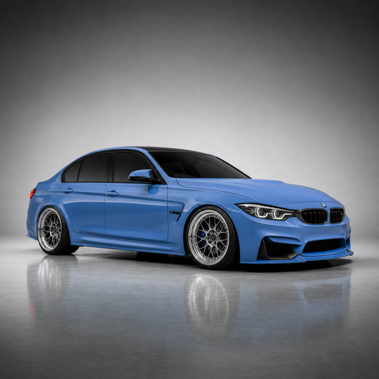 Light blue BMW M3 performance build in a studio