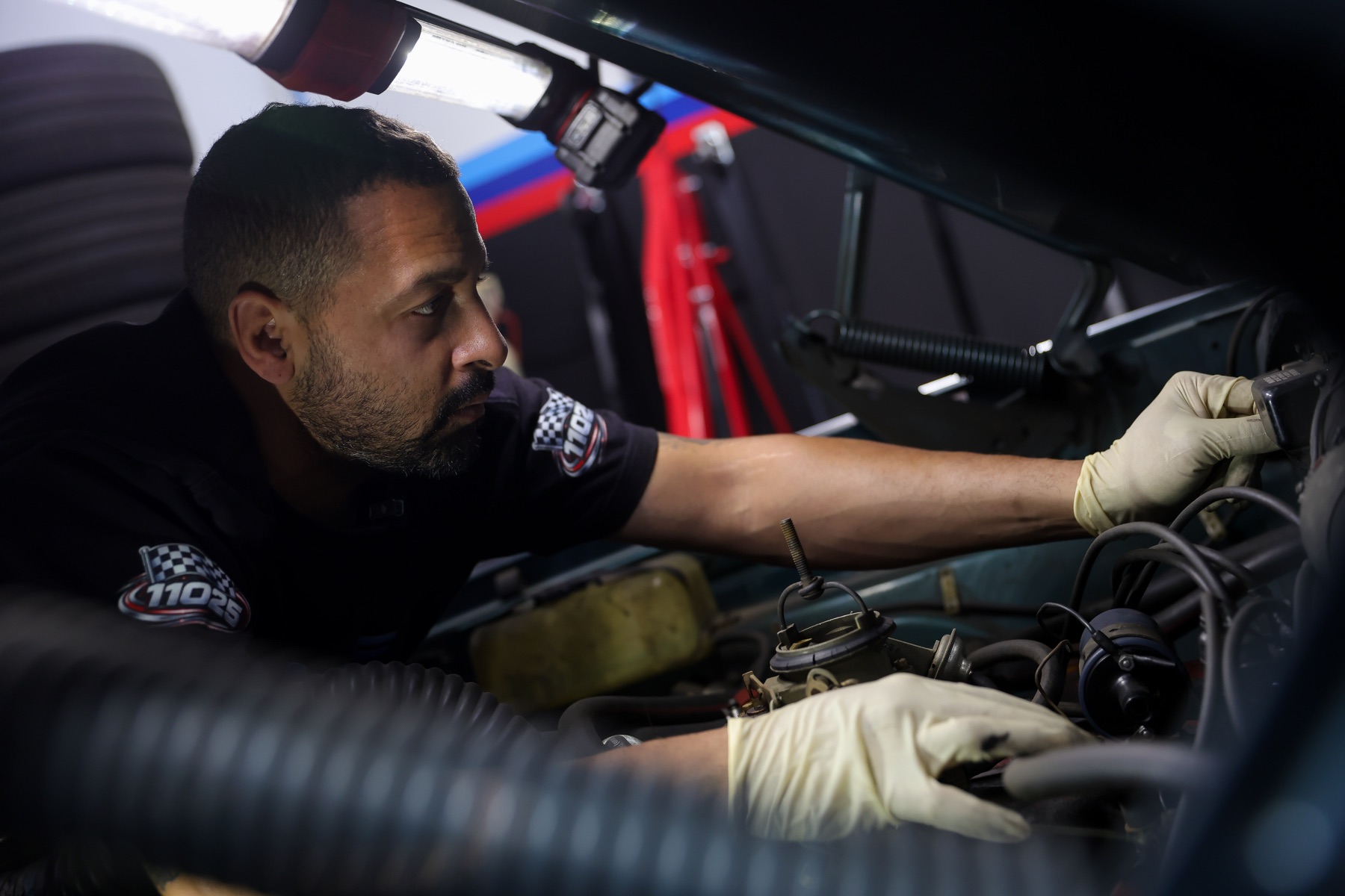 Quazie Motor Sports technician working inside an engine bay