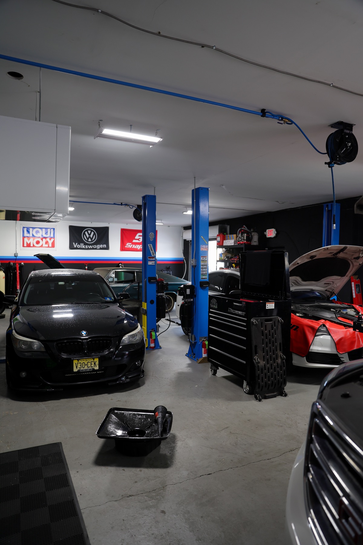 Wide view of the Quazie Motor Sports workshop and service lifts