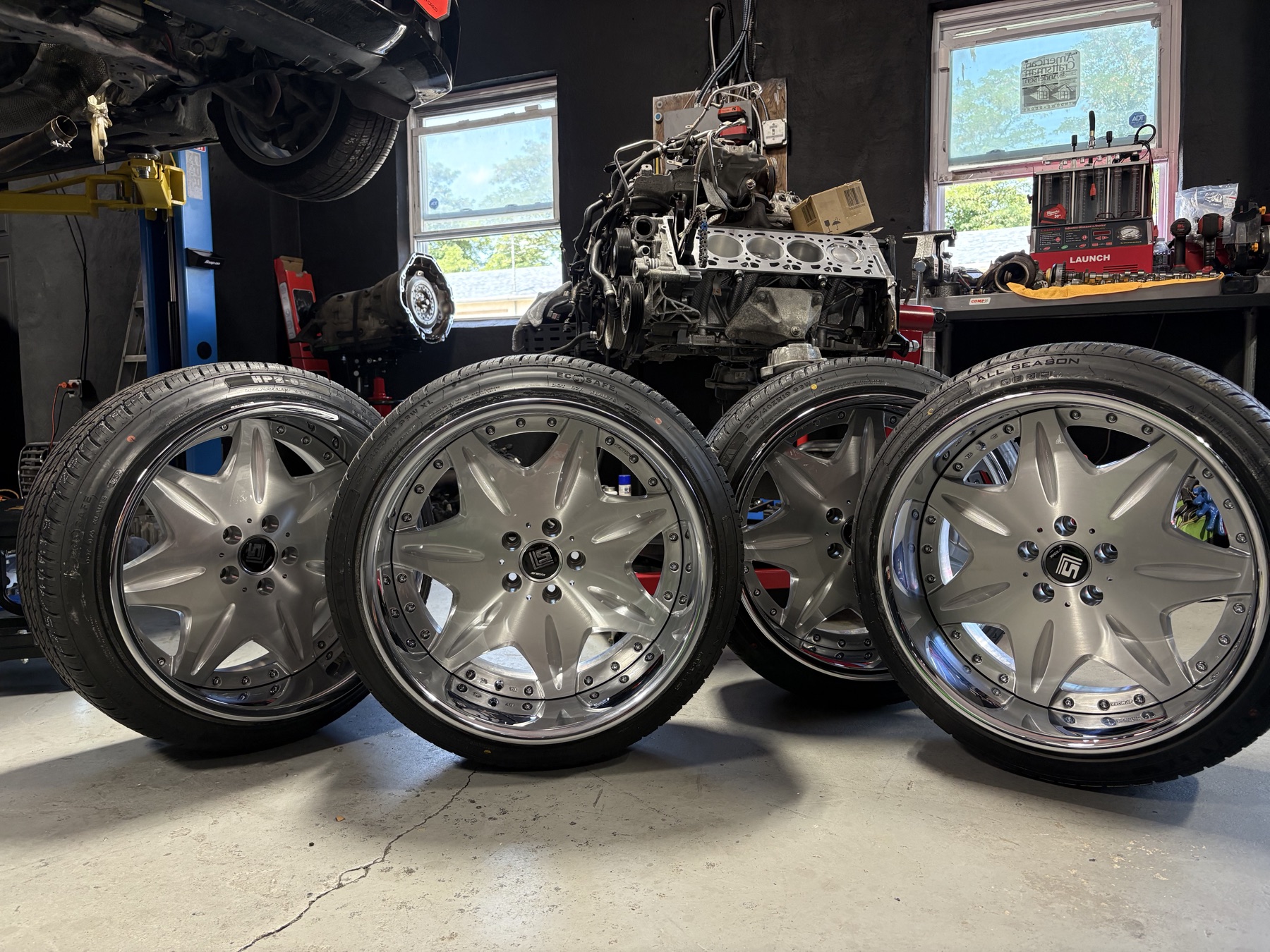 Performance wheels displayed in front of an engine build