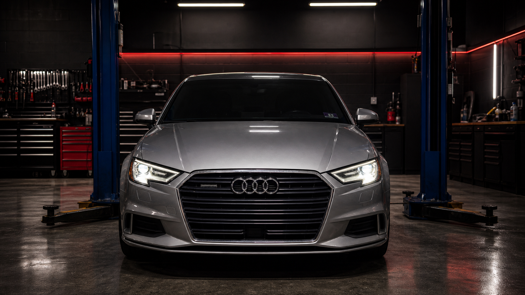 Silver Audi sedan in a QMSPORTS performance shop bay